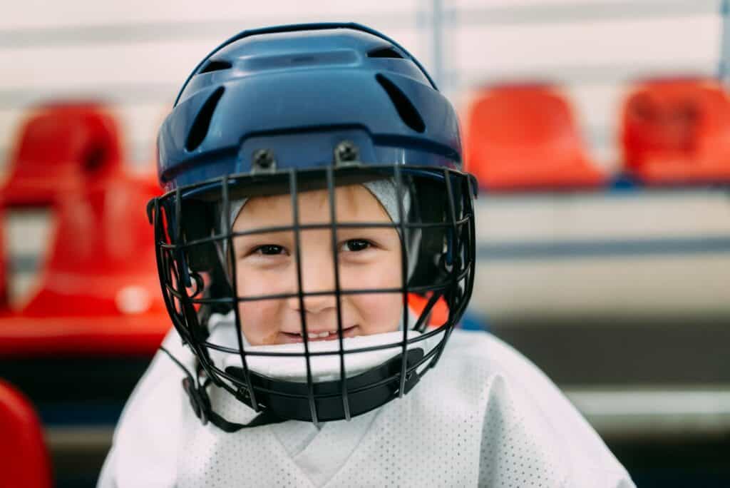 A boy on hockey practice at the ice rink.